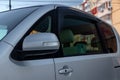 Side rear-view mirror on the body of a minivan of gray color with elements of chromed iron in the design Royalty Free Stock Photo