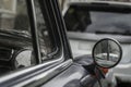 side rear rear view mirror of a classic vintage retro car. Old black vehicle with chrome details vintage round side view mirror Royalty Free Stock Photo