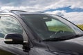 Side rear view mirror on a modern black car outdoor. Close-up of automobile detail Royalty Free Stock Photo