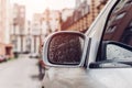 Side rear-view mirror on a modern car. Rainy water drops on glass Royalty Free Stock Photo