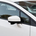 Side rear-view mirror on a white modern car. Square crop Royalty Free Stock Photo