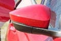 Side rearview mirror of red car