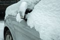 side rearview mirror with turn signal covered with snow.