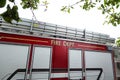 The side of a red fire truck with fire department written on the side. Royalty Free Stock Photo