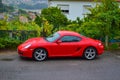 Side of a red Porsche Cayman 2.7 sport car, parked in a road o Royalty Free Stock Photo