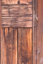 The side of a redwood house has vertical and horizontal planks