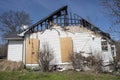 Side of residential home burned out by fire plywood boarded windows roof chared Royalty Free Stock Photo