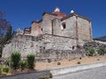 Side of San Pedro church in Mitla city, cobble road at archeological site of Zapotec culture on Oaxaca landscape, Mexico Royalty Free Stock Photo