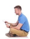 Side of a seated man working on a tablet Royalty Free Stock Photo