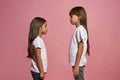 Side of serious little girls looking at each other Royalty Free Stock Photo