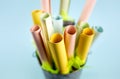 Side shallow depth of field view of pastel color paper rolls in container with copy space Royalty Free Stock Photo