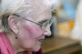 Aged woman in glasses with short gray hair