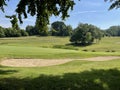 Side shot of a golf green with a bunker Royalty Free Stock Photo