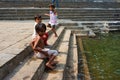 Side shot of happy children on the steps near Banganga water tank in Mumbai