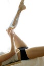 Side shot of a lady shaving her leg. Conceptual image shot