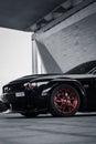 Side shot of a luxury shiny black dodge challenger car, vertical shot