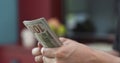 Side shot of man counting three thousand dollars Royalty Free Stock Photo