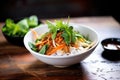 side shot of a pho bowl with hoisin and sriracha sauces Royalty Free Stock Photo