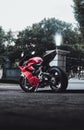 Side shot of a red motorcycle Ducati Panigale 1199, parked on the street
