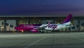 Side shot of wizzair airplane at airport at dusk after the sunset