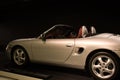 Side of a silver convertible at the Porsche museum