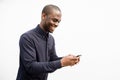 Side of smiling African American man using mobile phone by isolated white background Royalty Free Stock Photo