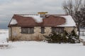 Side of stone block building covered in snow on cold winter day with overcast sky Royalty Free Stock Photo