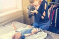 Side top view of mother taking a picture of her baby by DSLR camera Royalty Free Stock Photo