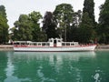 Side of touristic white boat moored at promenade on alpine Lake Annecy landscape in France Royalty Free Stock Photo