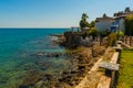 SIDE, TURKEY: View of the old Turkish houses on the street in the city of Side and the Mediterranean Sea. Royalty Free Stock Photo