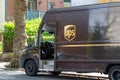 the side of a UPS delivery van parked on a street while delivering Royalty Free Stock Photo