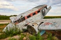 Side view of abandoned destroyed airplane resting in field Royalty Free Stock Photo