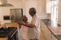 Senior couple dancing in a kitchen Royalty Free Stock Photo