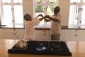 Senior couple dancing in a kitchen Royalty Free Stock Photo