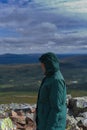 Side view of active female hiker enjoying the view on top of NipfjÃ¤llet mountain