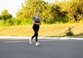 Side view of active sporty young running woman runner. Royalty Free Stock Photo