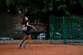 side view of active woman tennis player with tennis racket in her hand behind her back Royalty Free Stock Photo