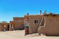 Side view of adobe mud buildings in a pueblo in the Southwestern USA, with shops with doors open for selling local crafts and Royalty Free Stock Photo