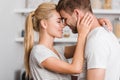 side view of affectionate couple hugging in kitchen and touching