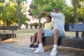 Side view of African American man hugging boy shoulder on bench Royalty Free Stock Photo