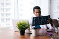 African American black male doctor is analyzing MRI brain head scan and working on laptop.