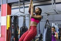 Female athletic climbing a rope in fitness center Royalty Free Stock Photo