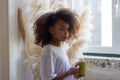 Side view of African American girl with yellow mug Royalty Free Stock Photo