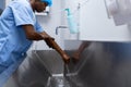 Male surgeon washing hands in sink at hospital Royalty Free Stock Photo