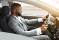 Side view of african american man in suit driving car Royalty Free Stock Photo