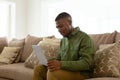 Man using laptop on sofa in living room at comfortable home Royalty Free Stock Photo