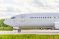 Side view of the aircraft cockpit, front landing gear, portholes, taxiing Royalty Free Stock Photo