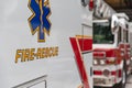 Side view of an ambulance rescue vehicle parking in front of a fire engine