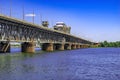 Side view of Amurskyi Bridge over the Dnieper river in Dnipro Ukraine on a sunny summer day. Landscape with an old metal bridge Royalty Free Stock Photo