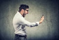 Angry man holding smartphone and shouting in anger